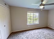 Thumbnail 10 of 35 - A room with a ceiling fan and a window.