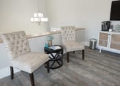 Thumbnail 9 of 26 - a leasing office with two chairs and a table