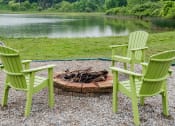 Thumbnail 18 of 26 - a group of green chairs sitting around a fire pit