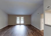 Thumbnail 5 of 35 - A room with wooden floors and a large window.
