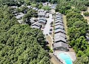 Thumbnail 25 of 26 - A bird's eye view of a residential area with houses and a swimming pool.