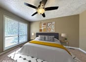 Thumbnail 8 of 26 - A bedroom with a large bed and a ceiling fan.