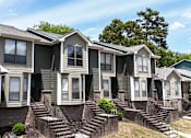 Thumbnail 22 of 26 - A row of houses with green siding and white trim.