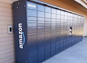 Thumbnail 13 of 26 - A large Amazon storage unit is parked in front of a building.