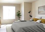Thumbnail 10 of 23 - a bedroom with a large bed and a plant in the corner of the room