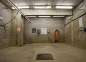 Thumbnail 13 of 23 - a carwash with two orange hoses and two white signs on the wall