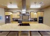 Thumbnail 21 of 23 - a kitchen with a large island and a stove top oven