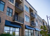 Thumbnail 23 of 23 - a brick apartment building with awnings