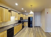 Thumbnail 5 of 23 - a kitchen with wooden cabinets and black appliances