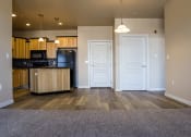 Thumbnail 6 of 23 - an open kitchen and living room with hardwood flooring