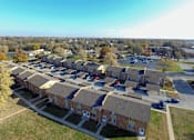 Thumbnail 4 of 7 - A row of houses with a parking lot in front.