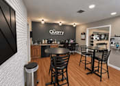 Thumbnail 2 of 9 - A modern dining area with a black table and chairs.