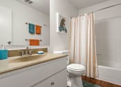 Thumbnail 14 of 31 - a bathroom with a sink and a toilet and a shower