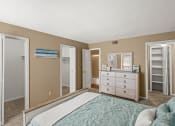 Thumbnail 7 of 31 - a bedroom with a bed and a dresser