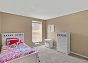 Thumbnail 9 of 31 - a bedroom with a bed and a dresser