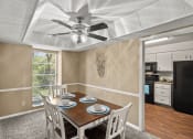 Thumbnail 2 of 31 - a dining room with a table and chairs and a ceiling fan