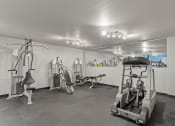 Thumbnail 21 of 31 - a gym with treadmills and other exercise equipment in a garage
