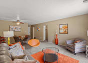 Thumbnail 12 of 31 - a living room with a couch and chairs and a ceiling fan