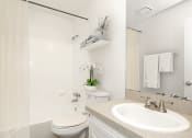 Thumbnail 5 of 29 - a bathroom with a toilet sink and bathtub