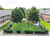 Thumbnail 34 of 34 - A green lawn with a white sign in the middle.
