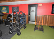 Thumbnail 14 of 28 - a room with a row of weights and a cart in it