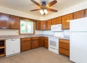 Thumbnail 1 of 28 - a kitchen with wooden cabinets and a ceiling fan