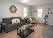 Thumbnail 5 of 28 - a living room with gray walls and a large clock on the wall