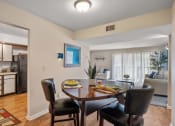 Thumbnail 6 of 27 - a dining room with a table and chairs