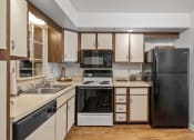 Thumbnail 12 of 27 - a kitchen with a stove top oven next to a refrigerator
