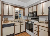 Thumbnail 14 of 27 - a kitchen with a stove top oven next to a sink