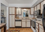 Thumbnail 13 of 27 - a kitchen with a stove top oven next to a sink