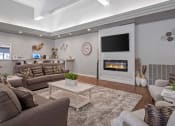 Thumbnail 27 of 27 - a living room with couches a coffee table and a fireplace