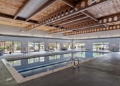 Thumbnail 19 of 27 - a large indoor swimming pool with a wooden ceiling