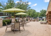 Thumbnail 20 of 27 - a patio with tables chairs and umbrellas