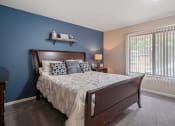 Thumbnail 7 of 27 - a bedroom with a bed and a window