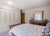 Thumbnail 8 of 27 - a bedroom with a bed and a dresser