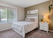 Thumbnail 9 of 27 - a bedroom with a bed next to a window