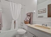 Thumbnail 11 of 27 - a bathroom with a sink toilet and bathtub