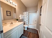 Thumbnail 9 of 29 - A spacious white bathroom with a toilet, sink, and shower.