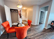 Thumbnail 13 of 29 - A dining room with a table set for two and two chairs.