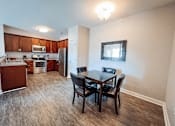 Thumbnail 5 of 29 - A kitchen with a dining table and chairs.