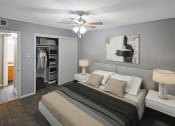 Thumbnail 1 of 22 - a bedroom with a bed and a ceiling fan