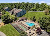 Thumbnail 29 of 35 - A large building with a pool in front of it.