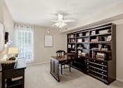 Thumbnail 10 of 35 - A room with a desk, chair, and bookshelf.