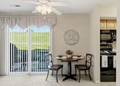 Thumbnail 3 of 35 - A dining room with a table set for two and a view of a green lawn outside.