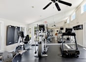 Thumbnail 14 of 35 - A spacious gym with a variety of exercise equipment.