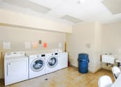 Thumbnail 13 of 15 - a laundry room with washing machines