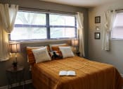 Thumbnail 6 of 16 - apartment bedroom with a bed and a window