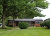 Thumbnail 10 of 16 - apartment complex with a yard and trees in front of it