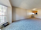 Thumbnail 3 of 35 - A room with a carpeted floor and a window.